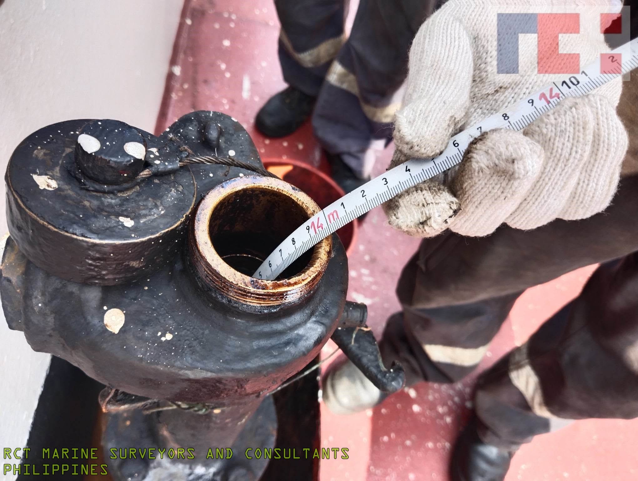 Marine surveyor measuring vessel equipment